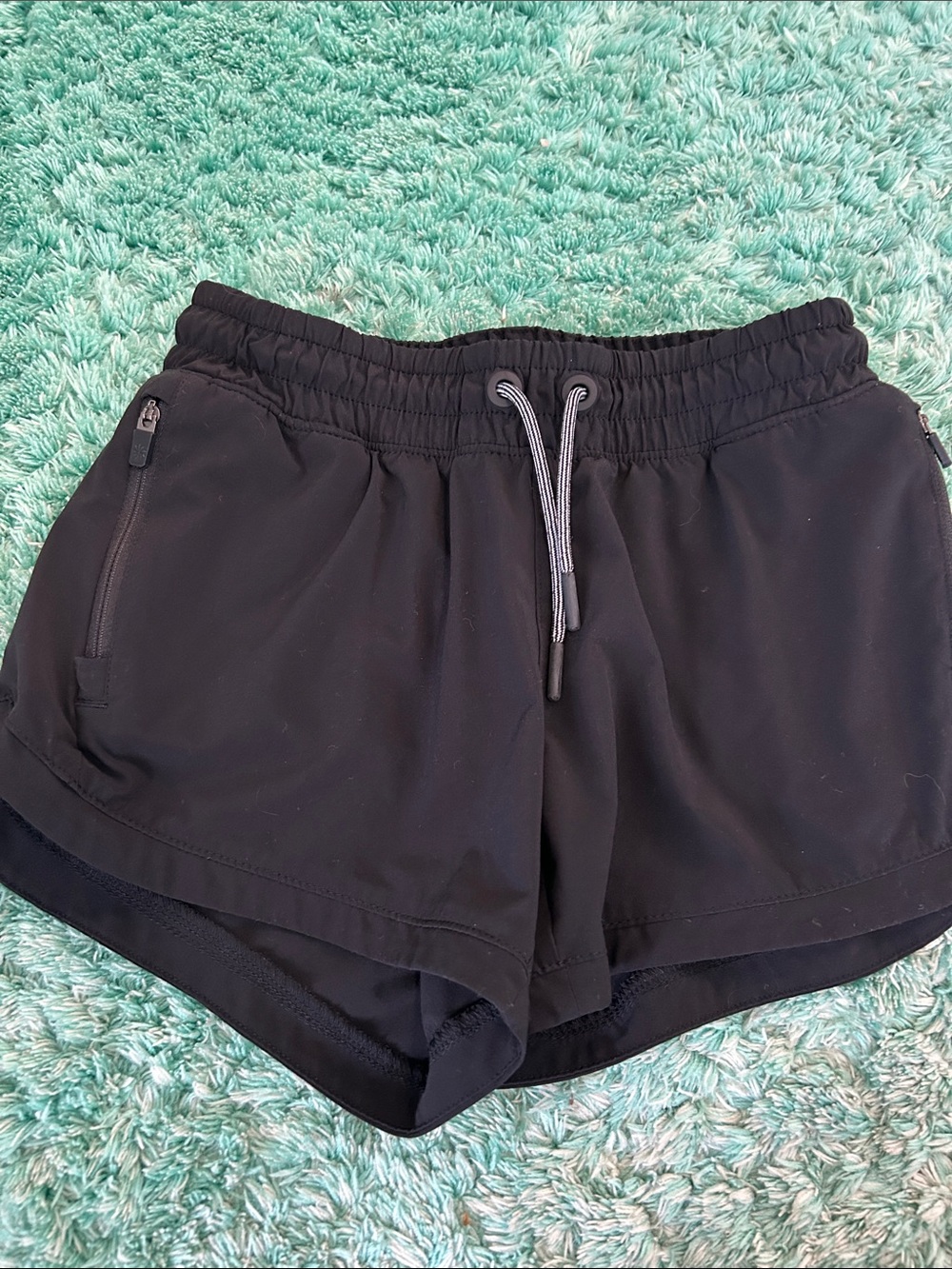 Athleta Girl Athletic Shorts with zipped pockets. Unlined. Size M